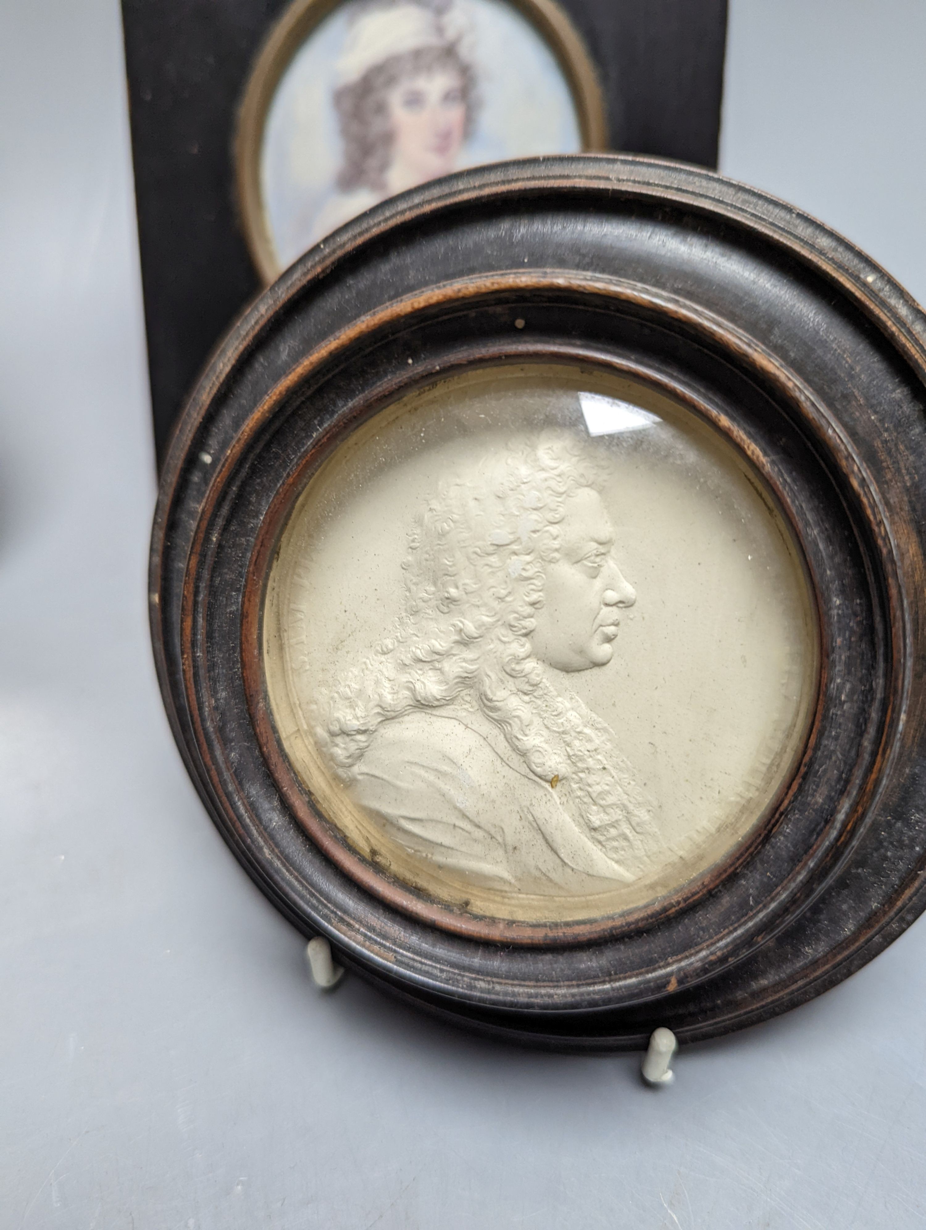 A plaster relief portrait, Samuel Pepys, frame 13cm., a Victorian portrait miniature on ivory, a silhouette portrait and a woven silk picture